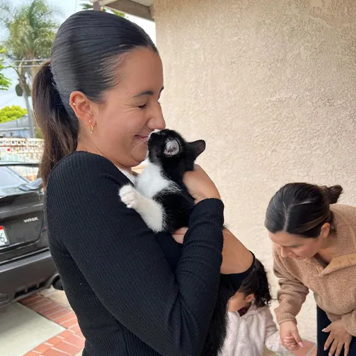A volunteer holding a rescued cat